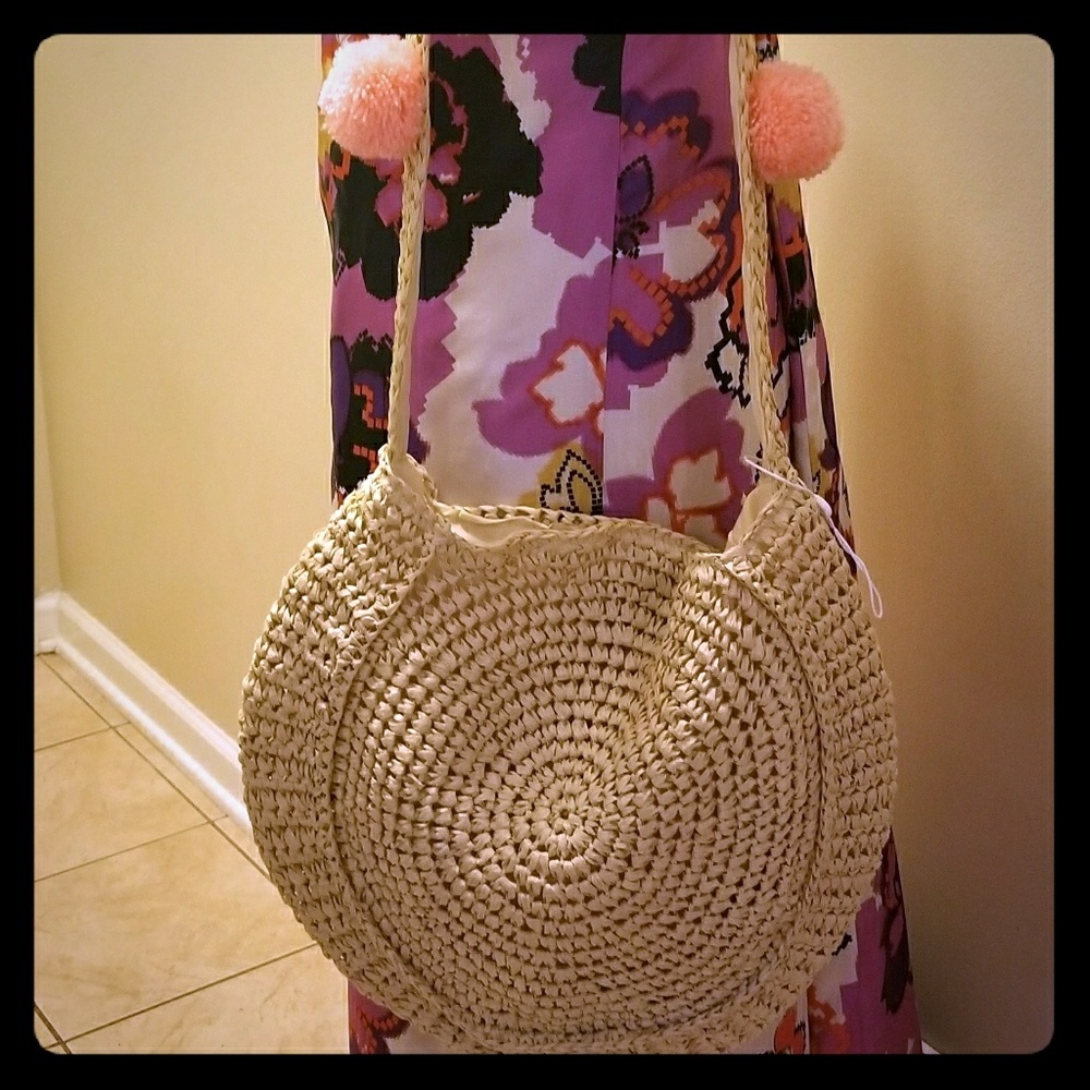 Straw bag with colorful pom poms
